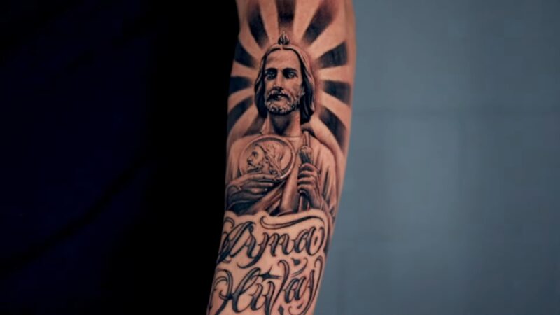 San Judas with a Medallion tatto